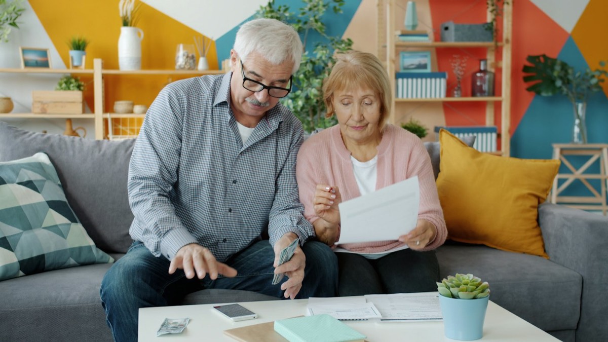 Couple reviewing solar paperwork at home